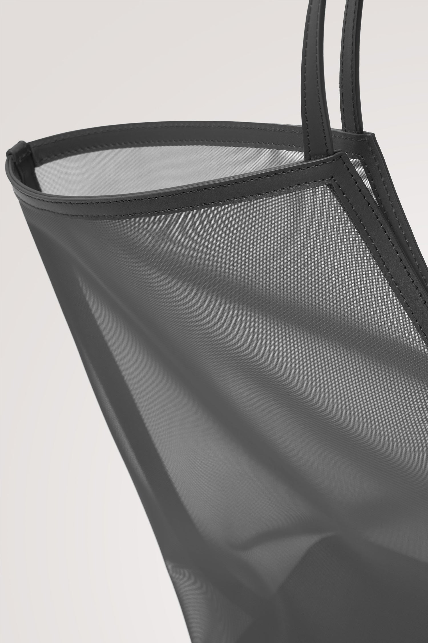 Roma Tote in Mesh With Spacious Trapeze Shape, Leather Trim, and Top Handles in Black Colorway - Side View Featured