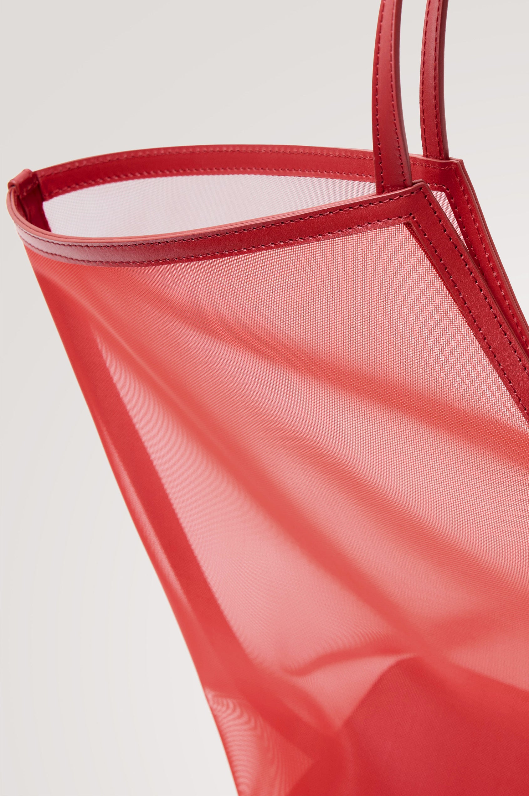 Roma Tote in Mesh With Spacious Trapeze Shape, Leather Trim, and Top Handles in Tomato Colorway - Side View Featured