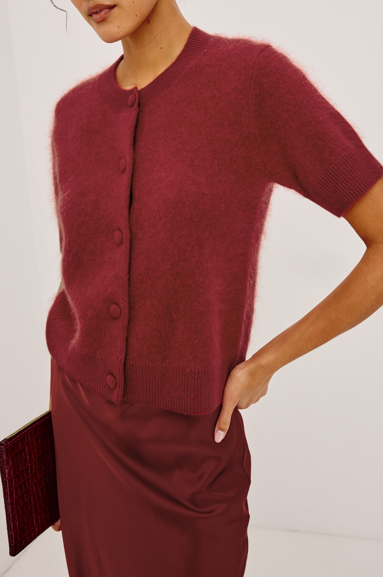 Roman Cardigan Sweater in Brushed Wool With Fluffy Feel With Slightly Cropped Fit, Crew Neck, Self-Covered Front Buttons, Short Sleeves, and Ribbed Trim in Crimson Colorway - Upper Body Front View Featured on Model