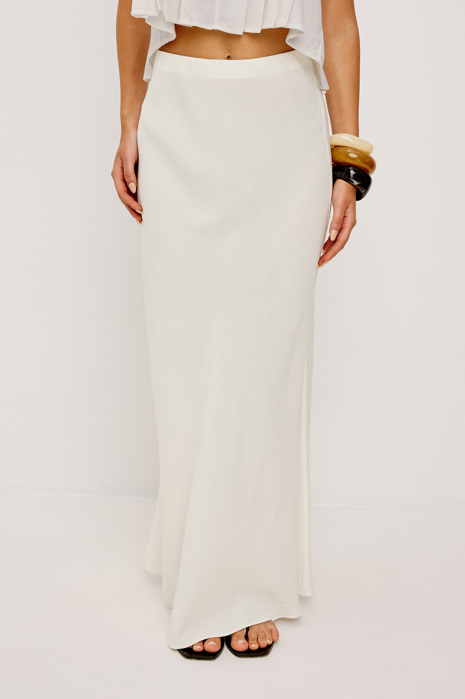 Romina High-Waisted Skirt in Linen With Elastic Waistband in Ivory Colorway - Lower Body Front View Featured on Model
