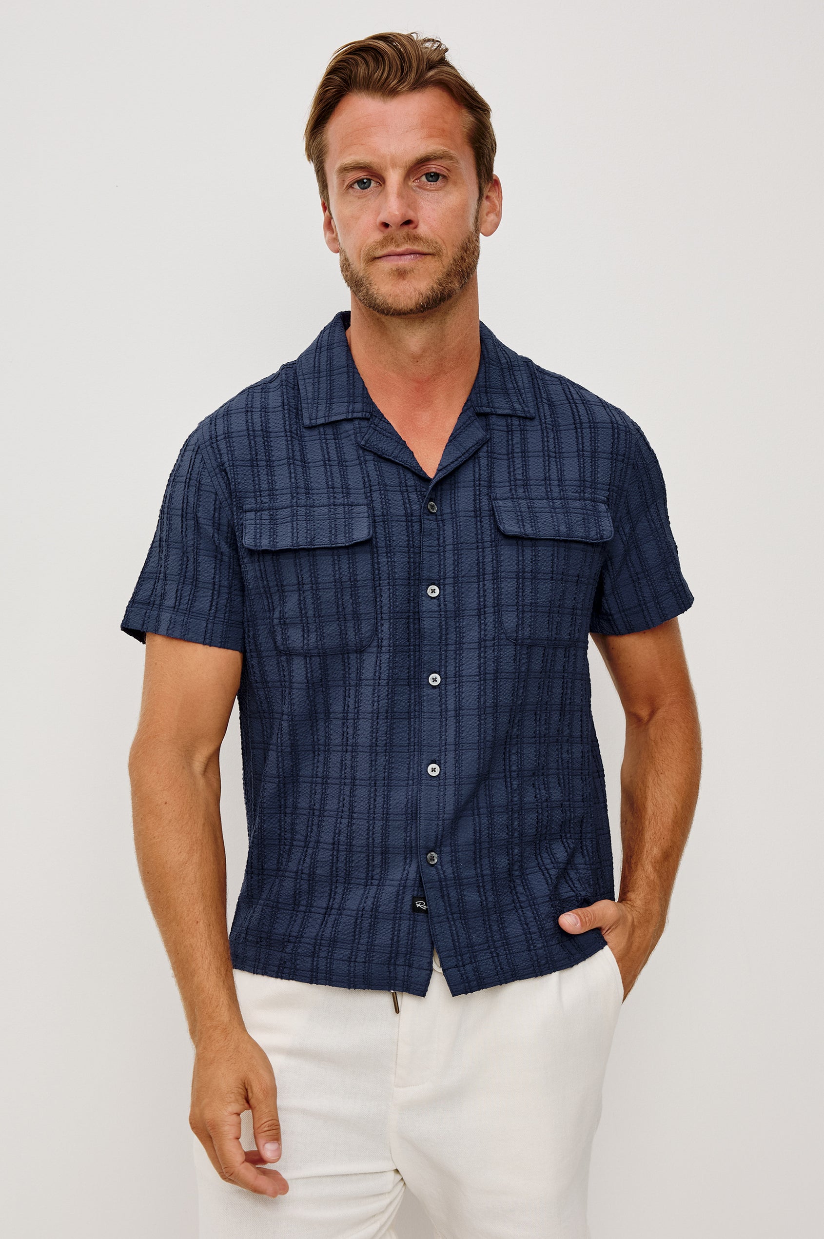 Rook Button-Up Shirt With Crosshatch Texture, Notched Collar, Short Sleeves, and Slightly Boxy Fit in Navy Colorway - Upper Body Front View Featured on Model