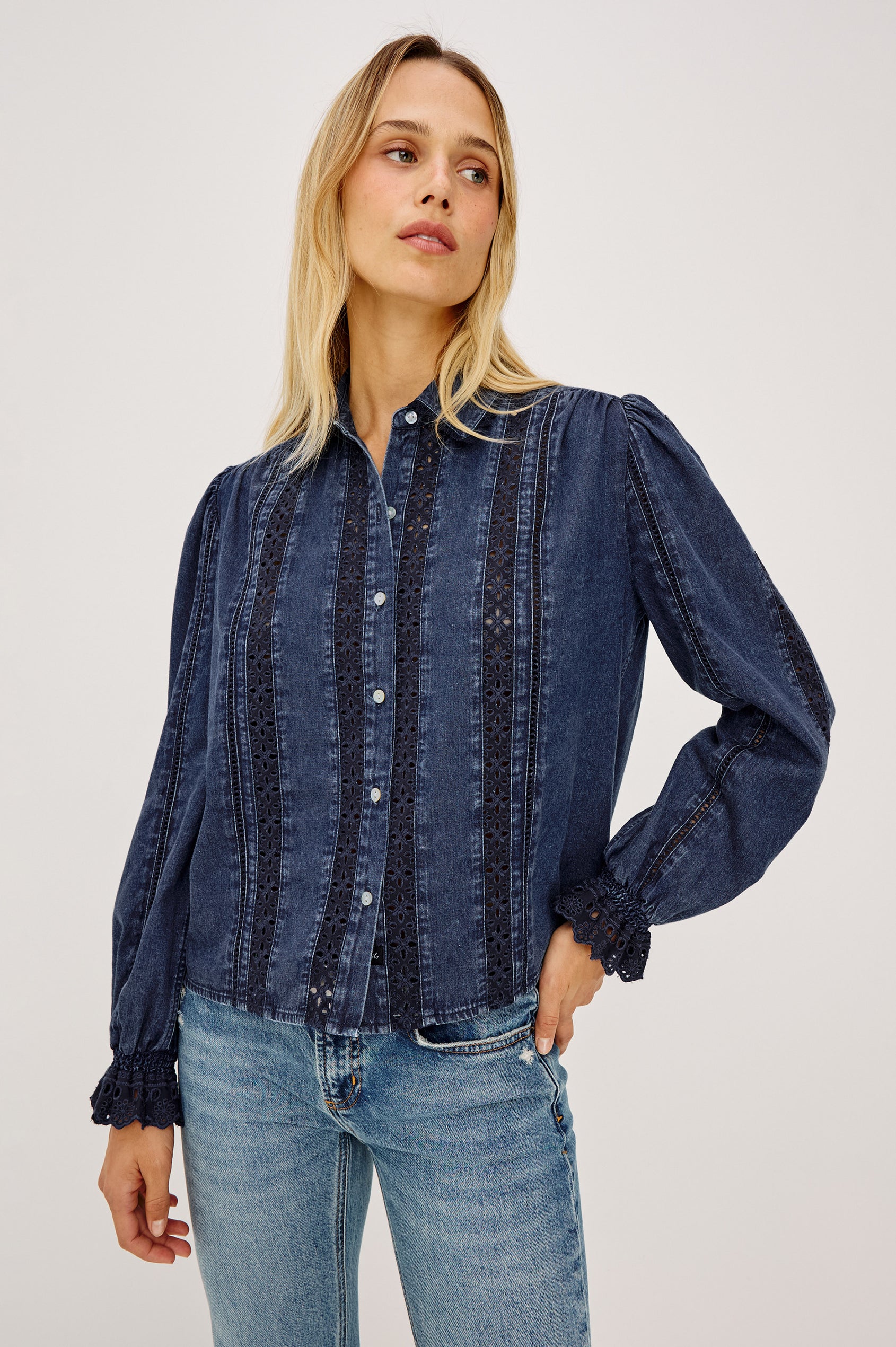 Rowen Shirt in Cotton Chambray With Cropped, Boxy Fit, Front Buttons, Long Puff Sleeves, Contrast Semi-Sheer Eyelet Panels, and Embroidered Trim at Collar and Flared Cuffs in Classic Blue Colorway - Upper Body Front View Featured on Model