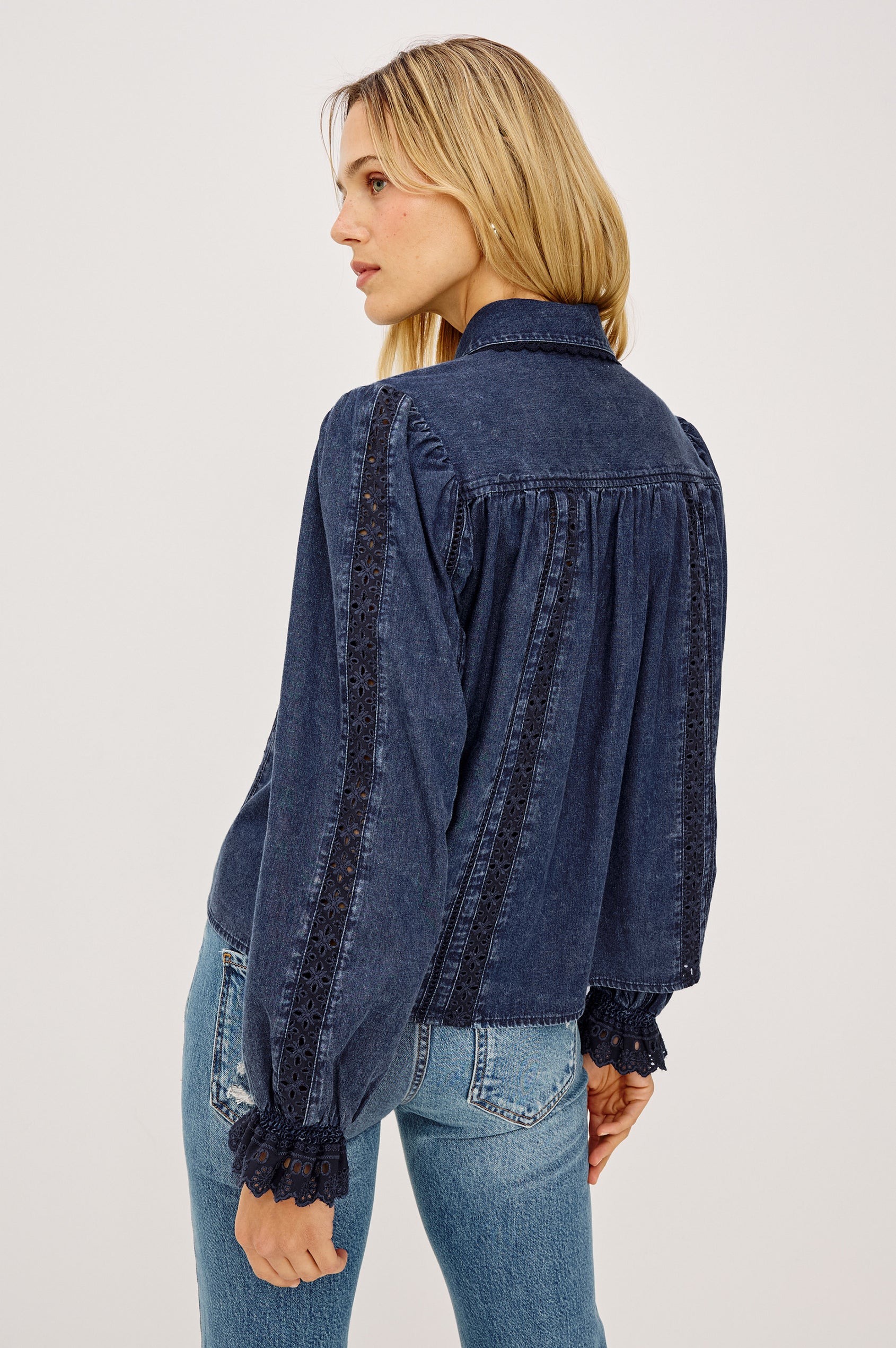 Rowen Shirt in Cotton Chambray With Cropped, Boxy Fit, Front Buttons, Long Puff Sleeves, Contrast Semi-Sheer Eyelet Panels, and Embroidered Trim at Collar and Flared Cuffs in Classic Blue Colorway - Upper Body Back View Featured on Model