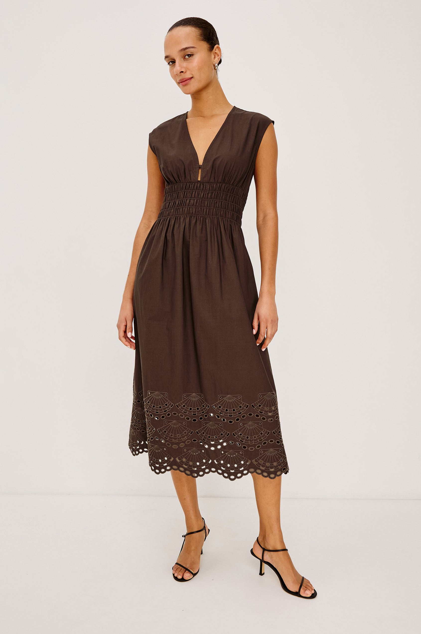 Roxanne Midi Dress in Cotton Poplin With Shirred Shoulders, Plunging V-Neck, Smocked Waist and Seashell Hem Embroidery in Espresso Colorway - Full Body Front View Featured on Model