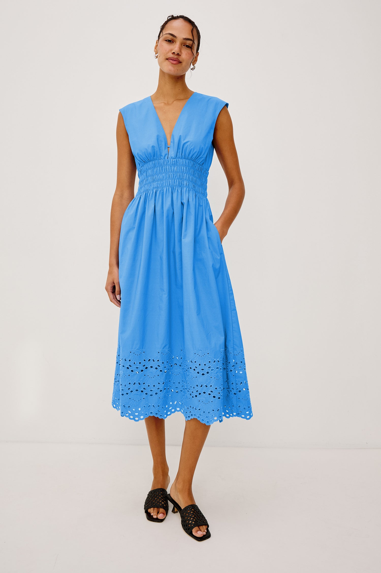 Roxanne Midi Dress in Cotton Poplin With Shirred Shoulders, Plunging V-Neck, Smocked Waist and Seashell Hem Embroidery in Harbor Blue Colorway - Full Body Front View Featured on Model