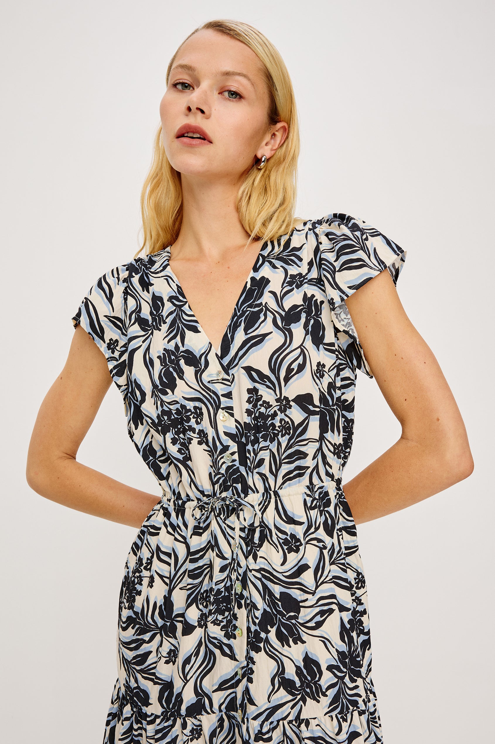 Roza Midi Dress in Cotton Poplin With V-Neckline, Flutter Sleeves, Front BUttons, Adjustable Waist Ties, and Tiered Lined Skirt in Zinya Colorway - Upper Body Front View Featured on Model