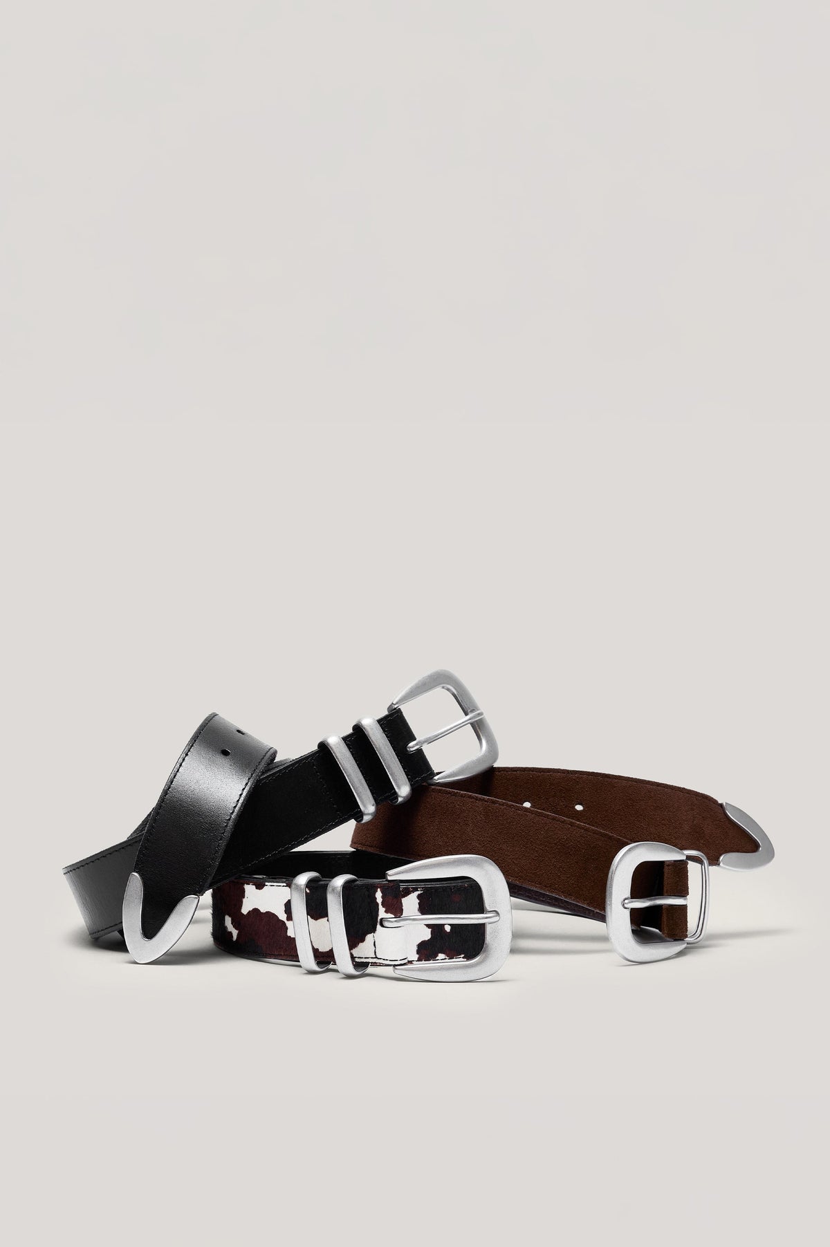 Ryder black leather belt with a brushed silver horseshoe-style buckle, matching dual loops, and a silver metal tip - front view featured on model.