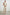 Rylee Sleeveless Ribbed Dress with a Scoop Neck, and a Fringed Asymmetrical Hemline from the Upper Thigh to the Knee in Ecru Colorway - Front Full Body View Featured on Model