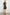 Samina Above-Knee Sleeveless Dress with drawstrings at the Arm Openings, Buttons along the Bodice, A Cinched Waist and a Tiered Skirt in Ash Leno Stripe Colorway, with Grey vertical stripes on black - Back Full Body View Featured on Model 
