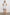 Samina Above-Knee Sleeveless Dress with drawstrings at the Sleeve Openings, Buttons along the Bodice, A Cinched Waist and a Tiered Skirt in Sonoma Stripe Colorway, Thin Vertical Blue Stripes on White - Front Full Body View Featured on Model 