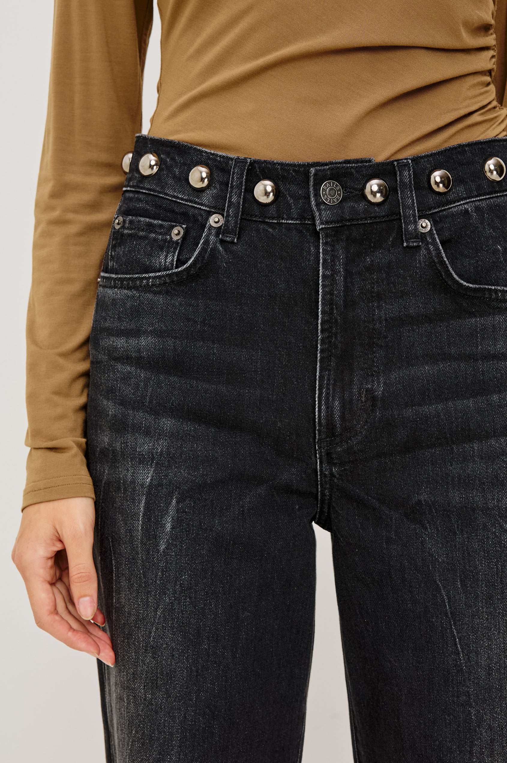 Samo Barrel Jean in Subtle Stretch Denim With Metallic Nail-Back Studs at Waist, 5-Pockets, and Front Zip-Fly in Black Stone Studded Colorway - Lower Body Front Close Up View Featured on Model