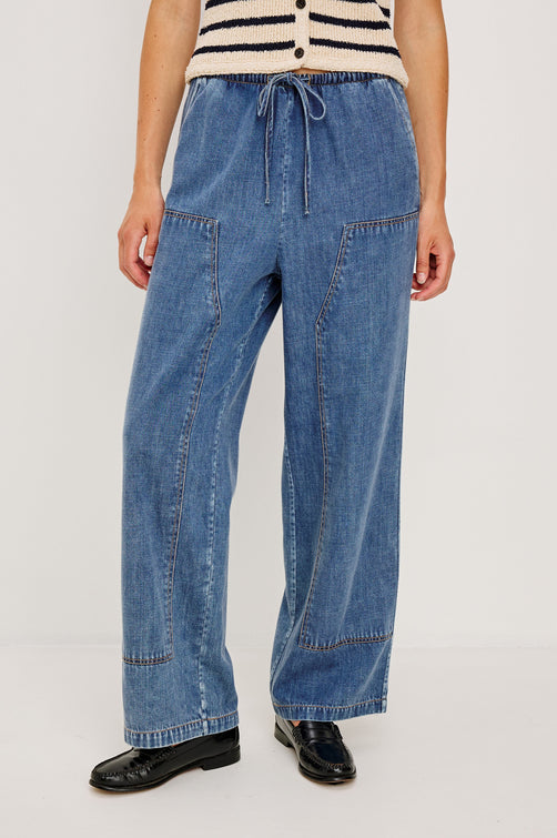 The Sanderson is a wide leg pull on pant with an encased drawstring waist tie, it has workwear inspired contrast topstitching on the front leg panels. Front view featured on model.