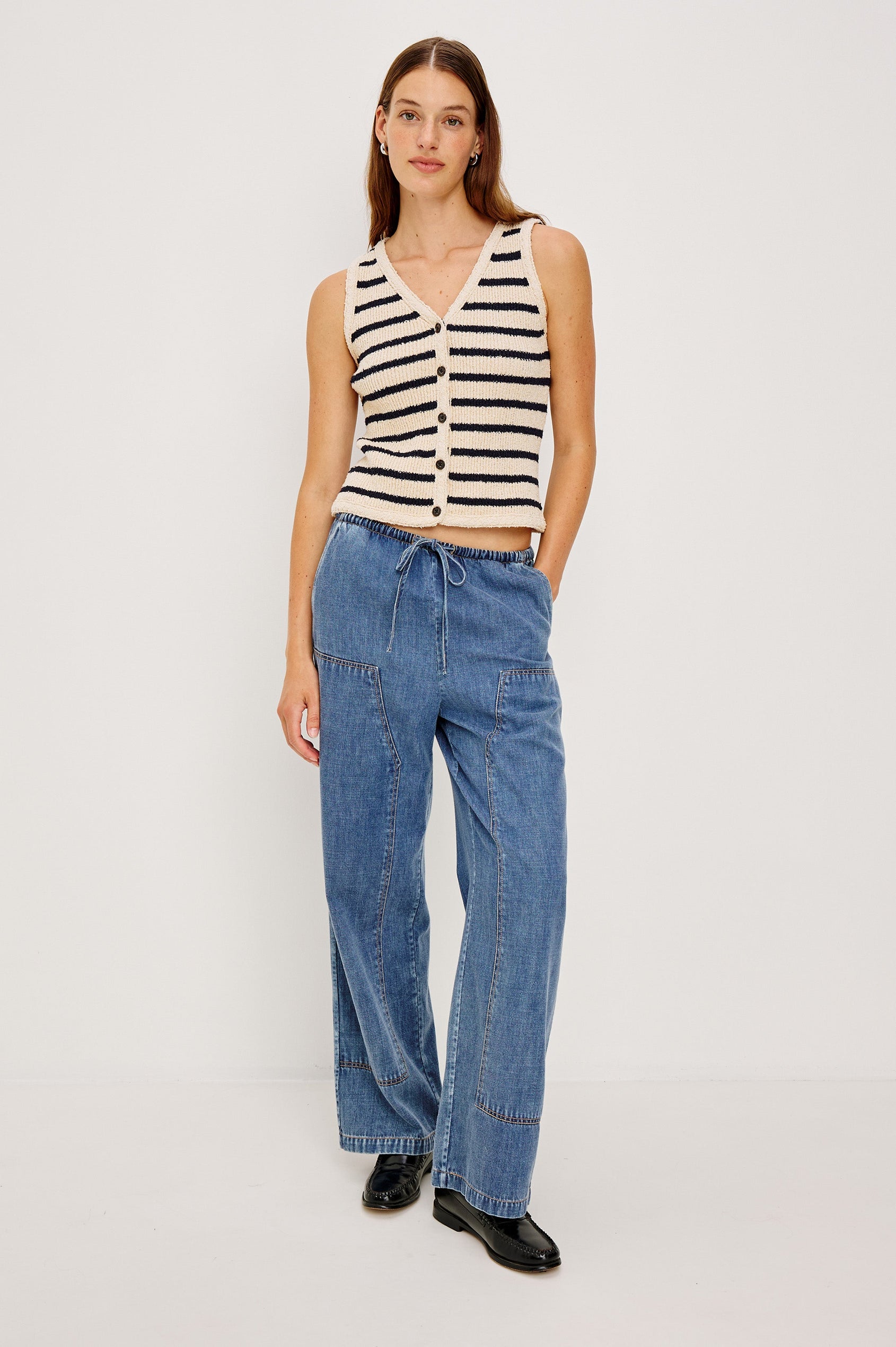 The Sanderson is a wide leg pull on pant with an encased drawstring waist tie, it has workwear inspired contrast topstitching on the front leg panels. Front full body view featured on model.