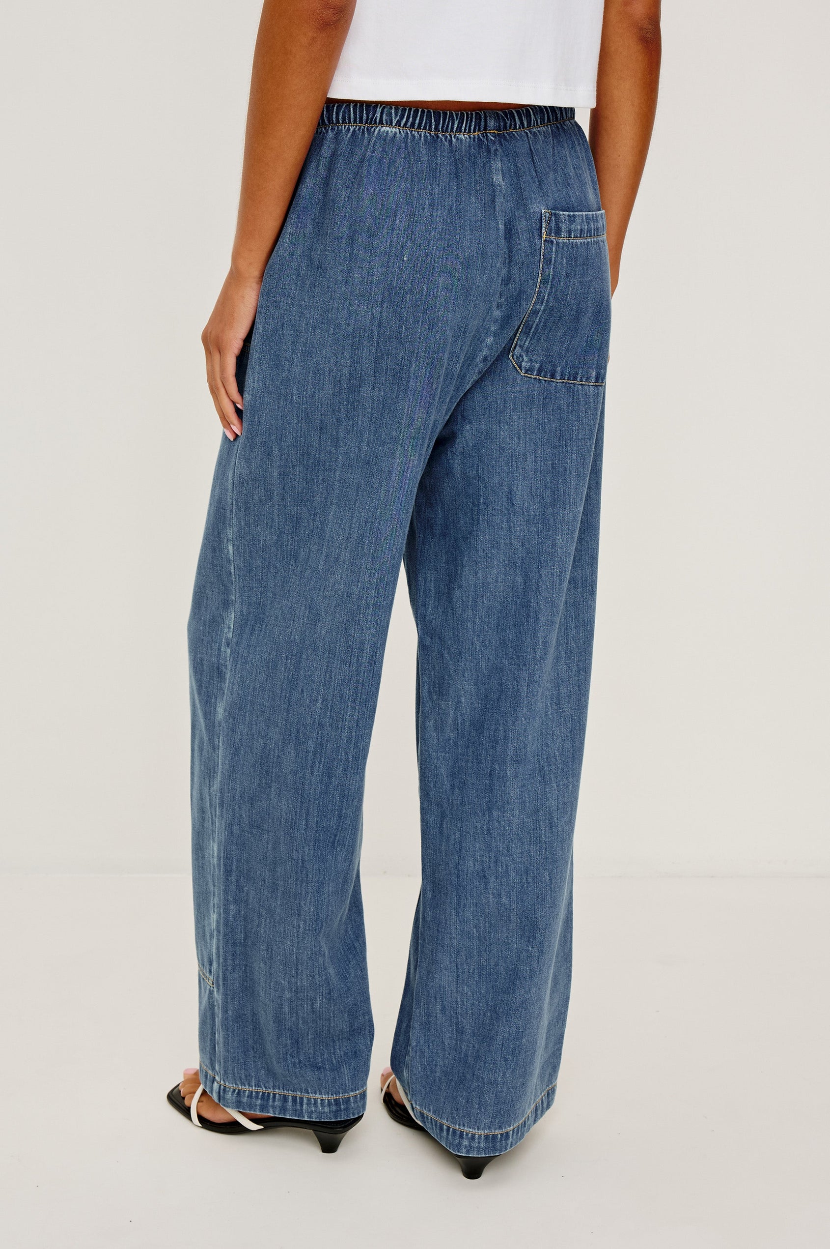The Sanderson is a wide leg pull on pant with an encased drawstring waist tie, it has workwear inspired contrast topstitching on the front leg panels. Back view featured on model.