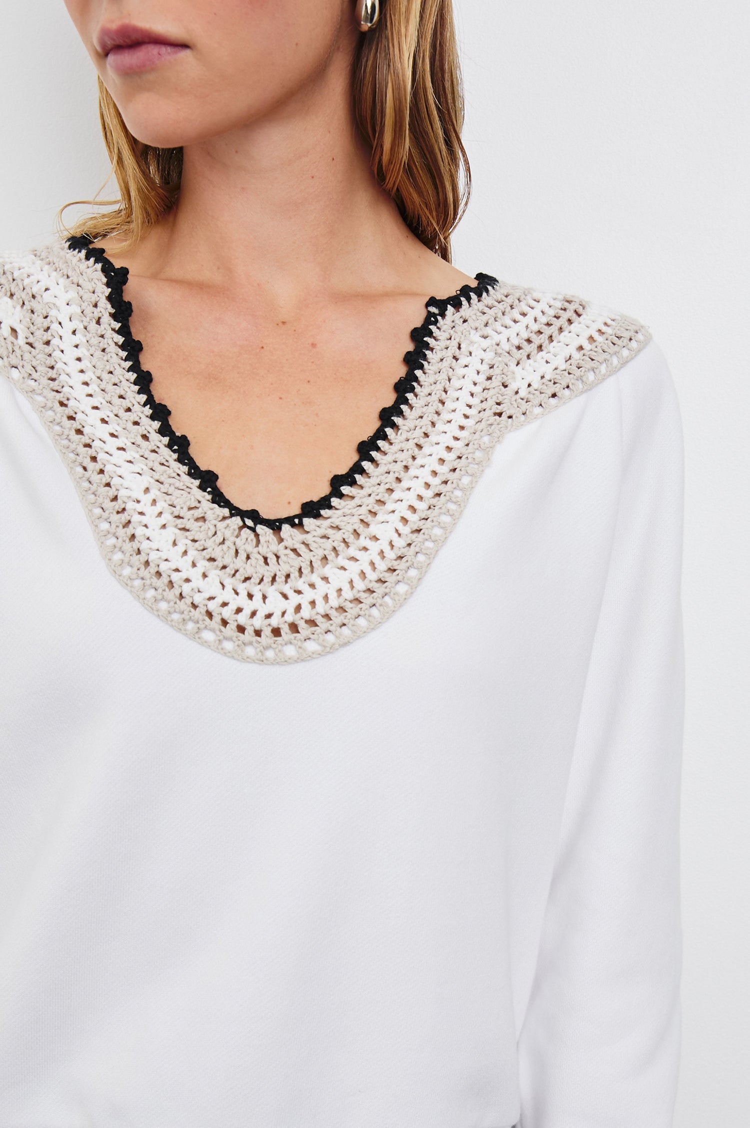 Sava Sweatshirt with V neck and Crochet along the Neckline in Ivory with Crochet Colorway, with cream, white and black crochet - Front View Featured on Model