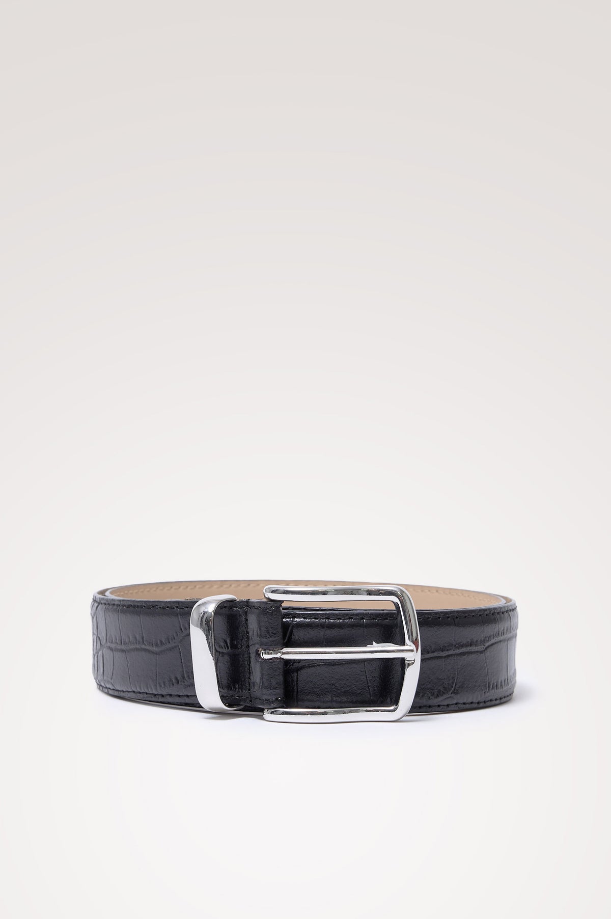 Savona Belt is crafted from croc-embossed leather, with topstitched edges and a metal tip in Black Croc Embossed Colorway - Front View Featured on Model.