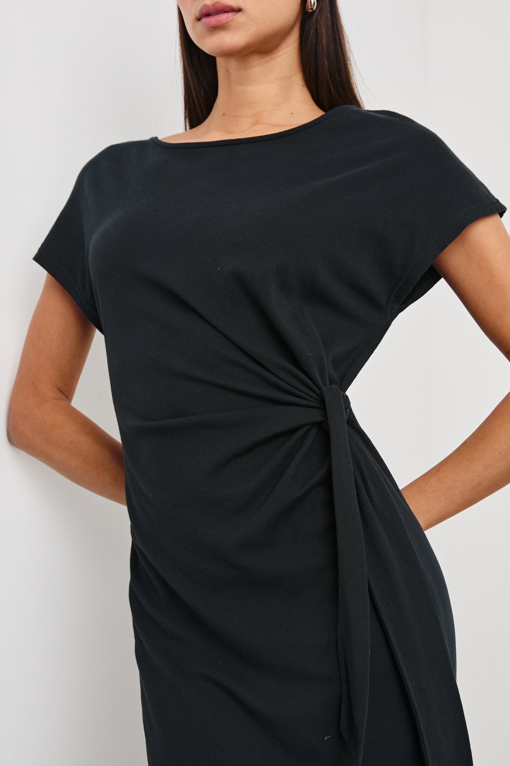 Selah Maxi Dress with Short Sleeves, Boatneck, Adjustable Side Tie at Waist and Two Mid-Calf Side Slits in Black Colorway  - Front View Featured on Model