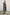 Selani Midi Dress With an Asymmetrical Neckline, Mid-Thigh Slide Slit and Cinched Waistband in Island Stripe Colorway, with alternating white and black horizontal and vertical stripes - Front Full Body View Featured on Model