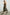 Selani Midi Dress With an Asymmetrical Neckline, Mid-Thigh Slide Slit and Cinched Waistband in Island Stripe Colorway, with alternating white and black horizontal and vertical stripes - Side Full Body View Featured on Model