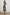 Selani Midi Dress With an Asymmetrical Neckline, Mid-Thigh Slide Slit and Cinched Waistband in Plumerias Colorway, with Ivory and Gold Plumerias on Dark Green  - Front Full Body View Featured on Model