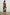 Selani Midi Dress With an Asymmetrical Neckline, Mid-Thigh Slide Slit and Cinched Waistband in Plumerias Colorway, with Ivory and Gold Plumerias on Dark Green  - Back Full Body View Featured on Model