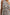 Selani Midi Dress With an Asymmetrical Neckline, Mid-Thigh Slide Slit and Cinched Waistband in Russet Floral Colorway, with white and tan flowers on russet - Front View Featured on Model