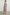 Selani Midi Dress With an Asymmetrical Neckline, Mid-Thigh Slide Slit and Cinched Waistband in Russet Floral Colorway, with white and tan flowers on russet - Back Full Body View Featured on Model