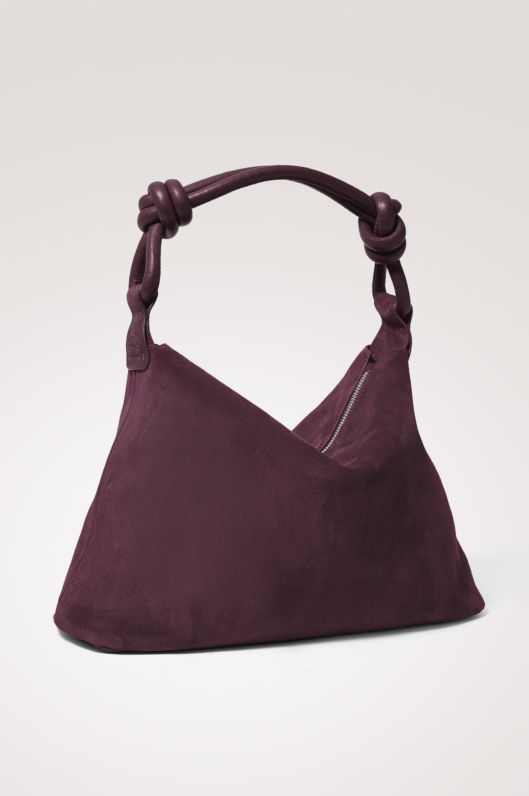 Siena Hobo Bag in Suede With Knotted Top Strap, Zip Closure With Fringe Tassel Pull, Microsuede Lining, Snap-Button Slip Pocket and Foil Logo Stamp at Interior in Plum Suede Colorway -