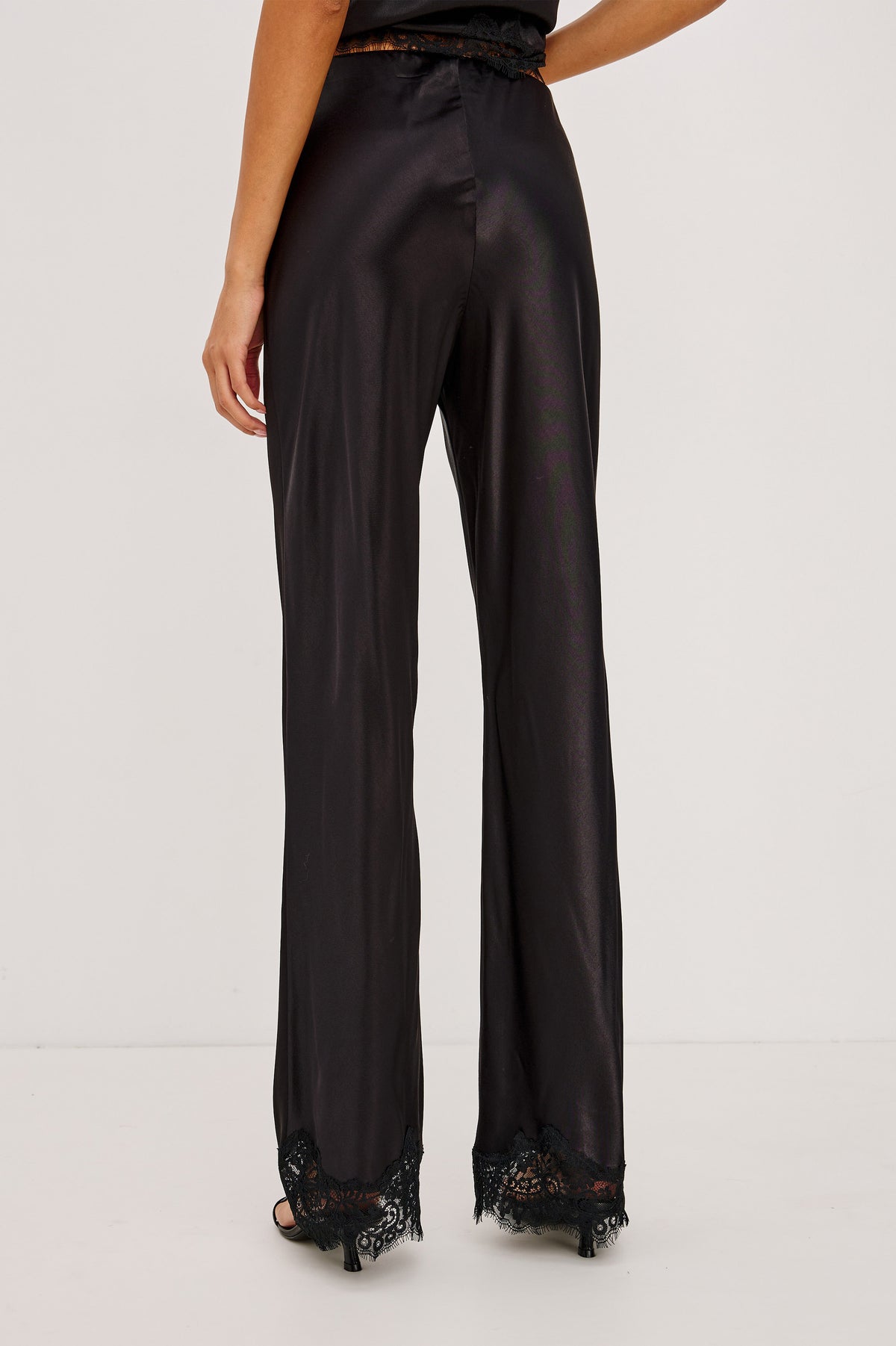 Silvi Pant in Satin-Back Crepe With Straight Legs, Elastic Waist, and Lace Hem in Black Colorway - Back Crop View Featured on Model.