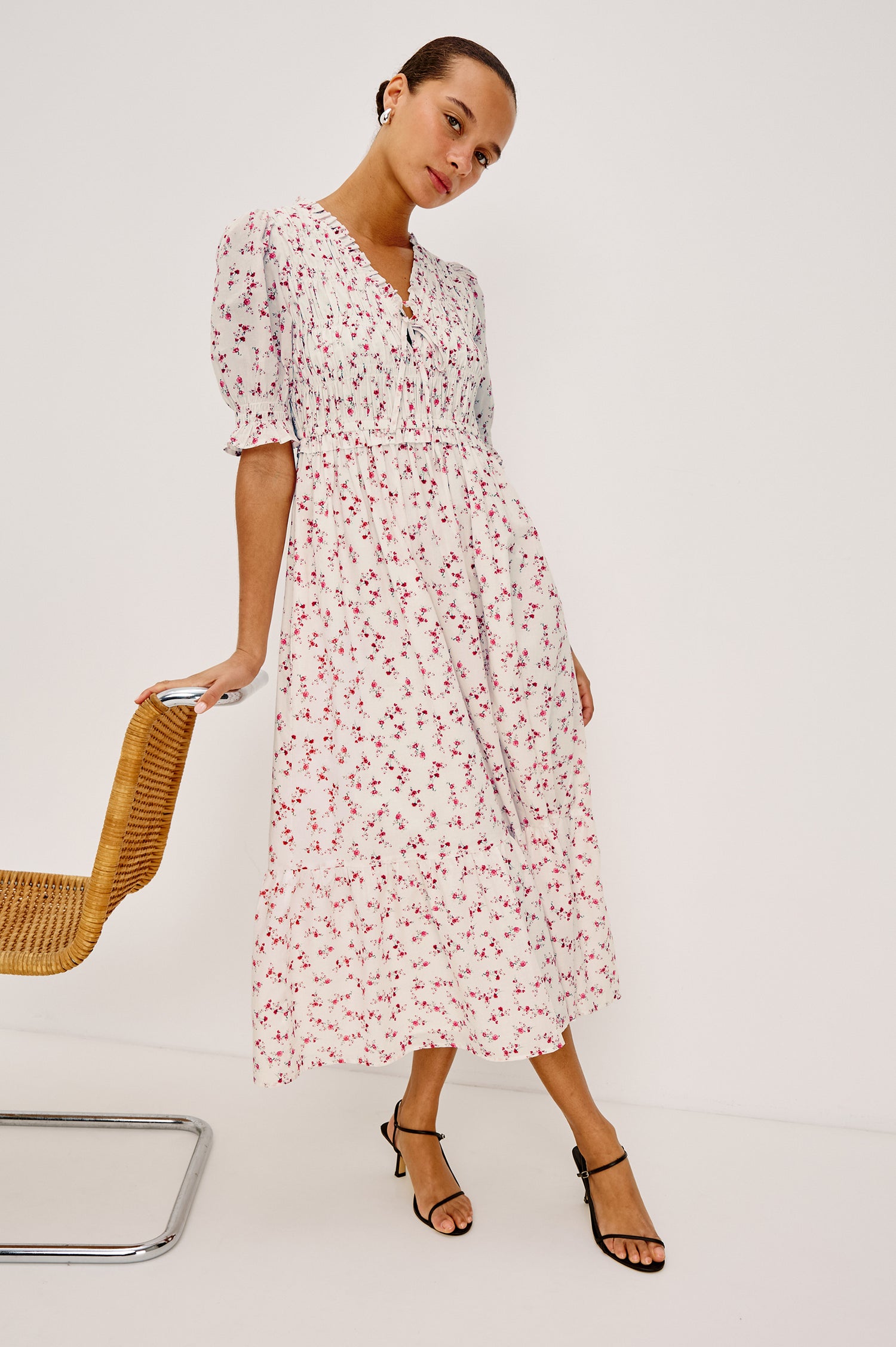 Sonica Midi Dress in Cotton With Fitted Smocked Bodice Plunging V-Neckline With Self-Ties Short Puff Sleeves and Single Tiered A-Line Skirt in Rouge Romantic Colorway - Full Body Front View Featured on Model