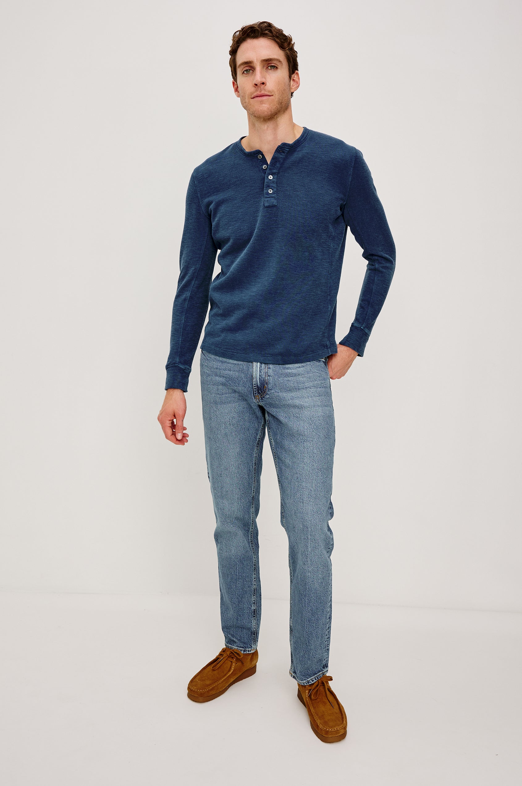 Soto Long-Sleeve Henley with a Four Button Placket and a Crew Neck in Vintage Indigo Colorway - Front Full Body View Featured on Model
