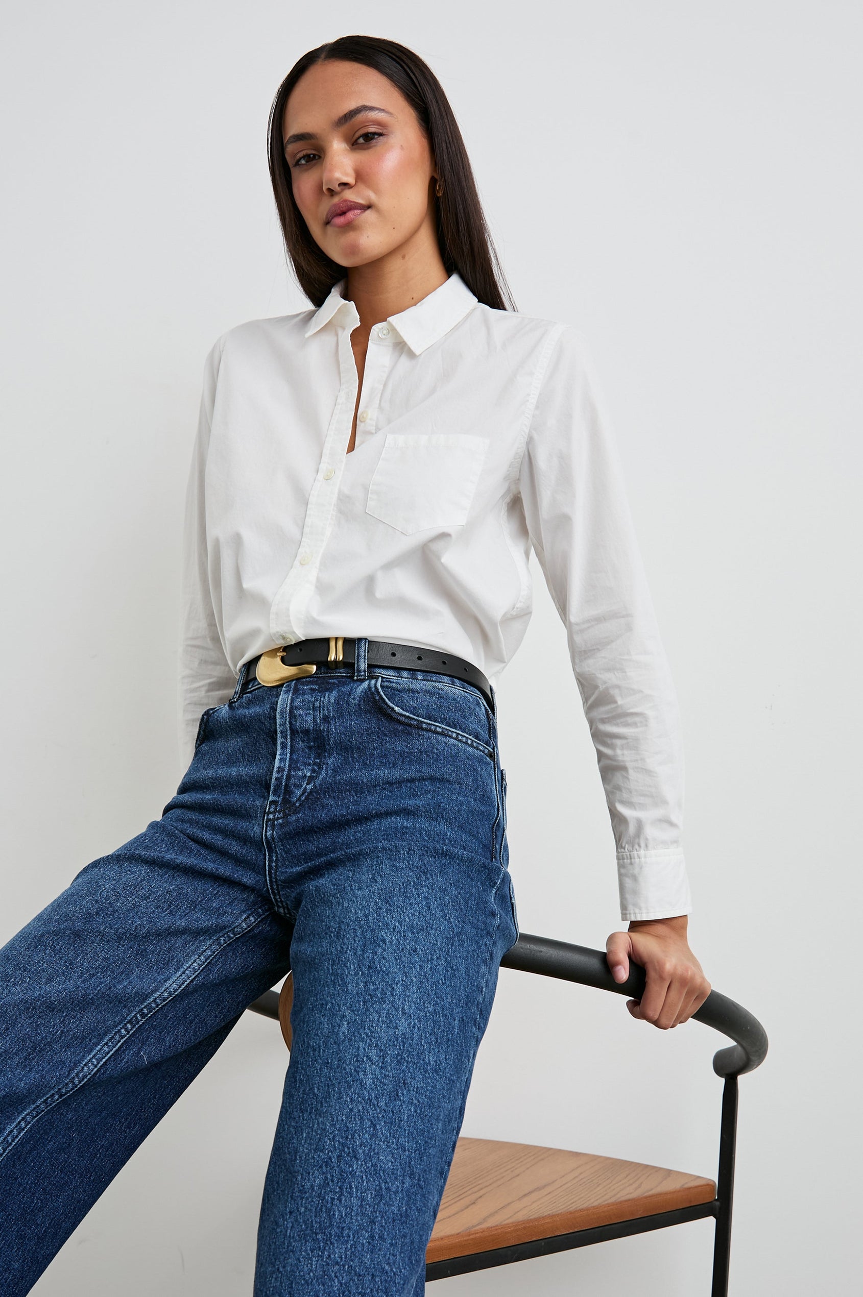 Stina Long-Sleeve Button Up with a Chest Patch Pocket in White Colorway - Front Tucked Full Body View Featured on Seated Model