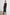 Syd Ribbed, Sleeveless Midi Dress with Wide Shoulder Straps, a Side Slit, and a Cutout that Spans the Lower Back in Black Colorway - Front Full Body View Featured on Model  