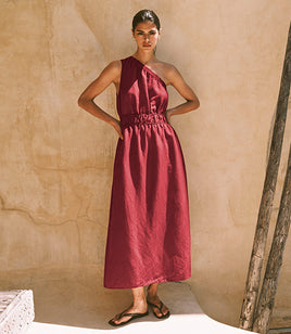 Woman in a red one shoulder maxi dress
