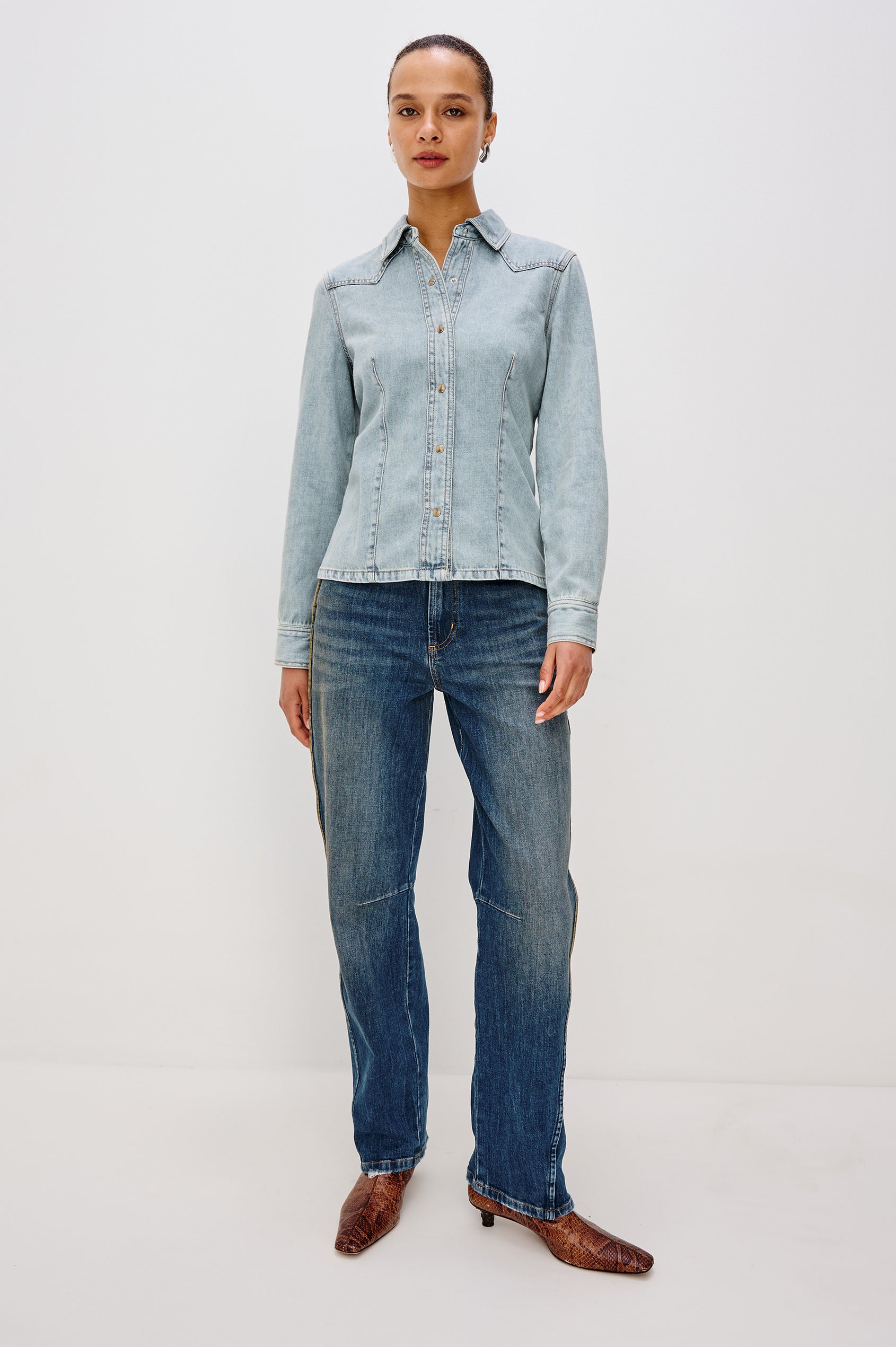 Taiana Cotton Lyocell Denim Shirt in Light Blue Wash With Western Yoke, Front and Back Darts for Fitted Silhouette, Front Pearl Snap Buttons, and Long Sleeves in Bleached Indigo Colorway - Full Body Front View Featured on Model