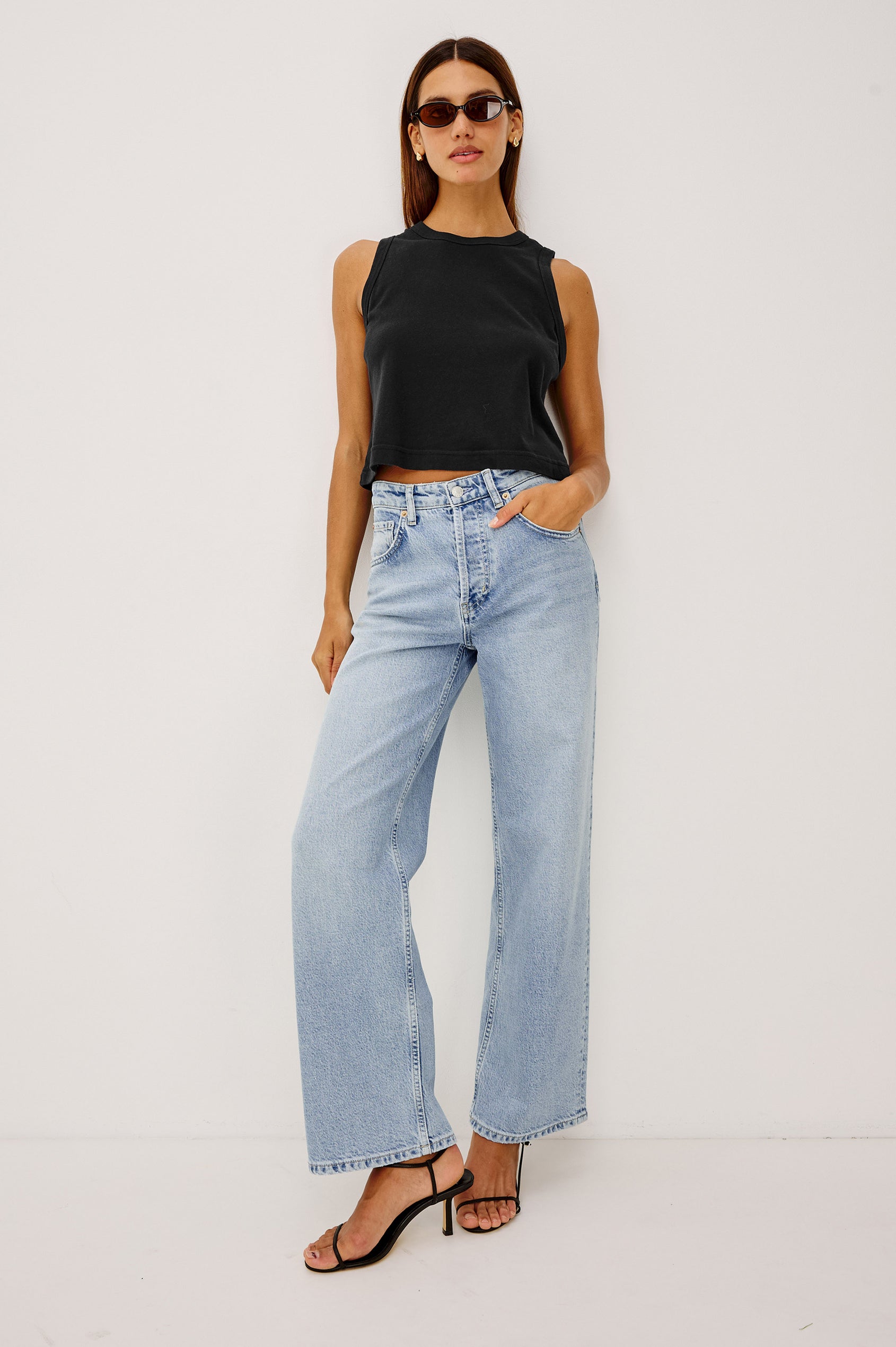 The Boxy Tank in 100% Cotton With Crew Neckline, Wide Shoulder Straps, and a Cropped, Boxy Fit in Black Colorway - Full Body Front View Featured on Model