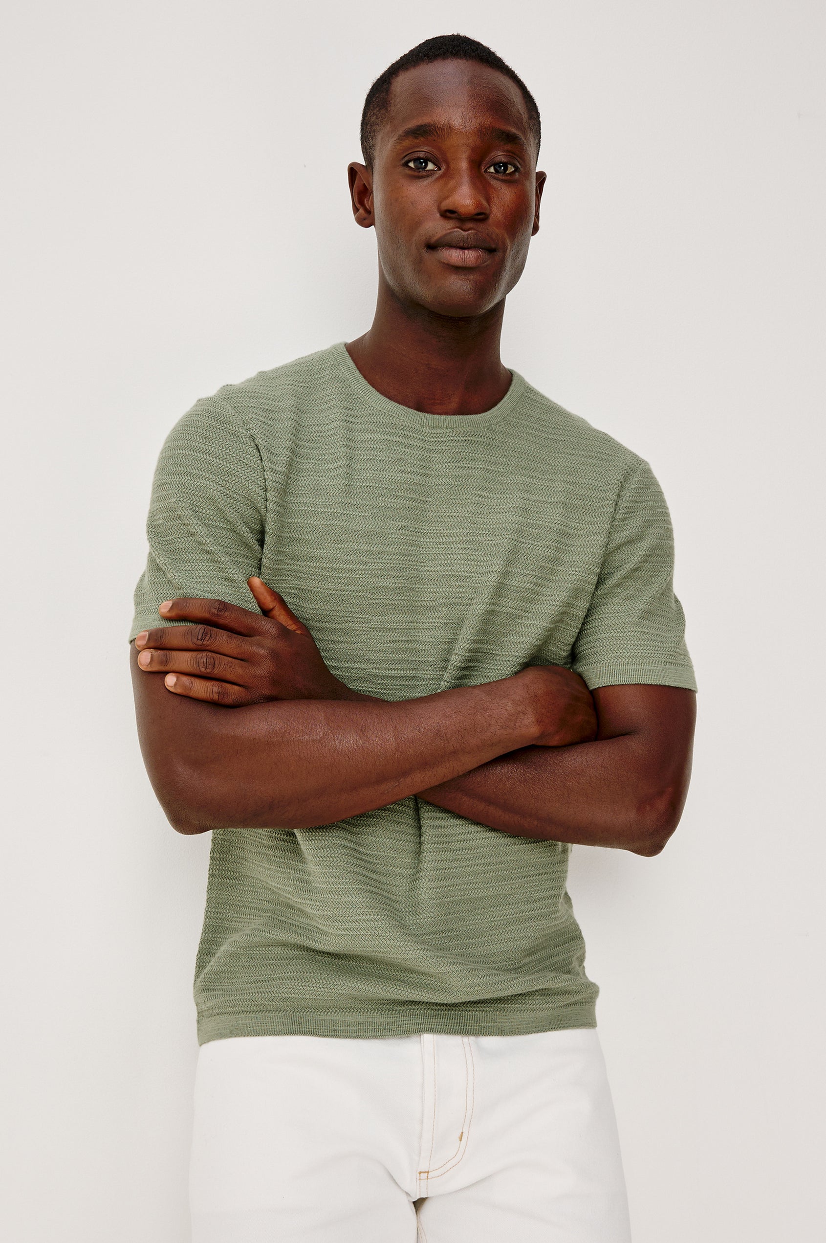 Nathan Polo Shirt in Cotton Blend Knit With Collar, Quarter Button Placket, and Short Sleeves in Silver Sage Colorway - Upper Body Front View Featured on Model