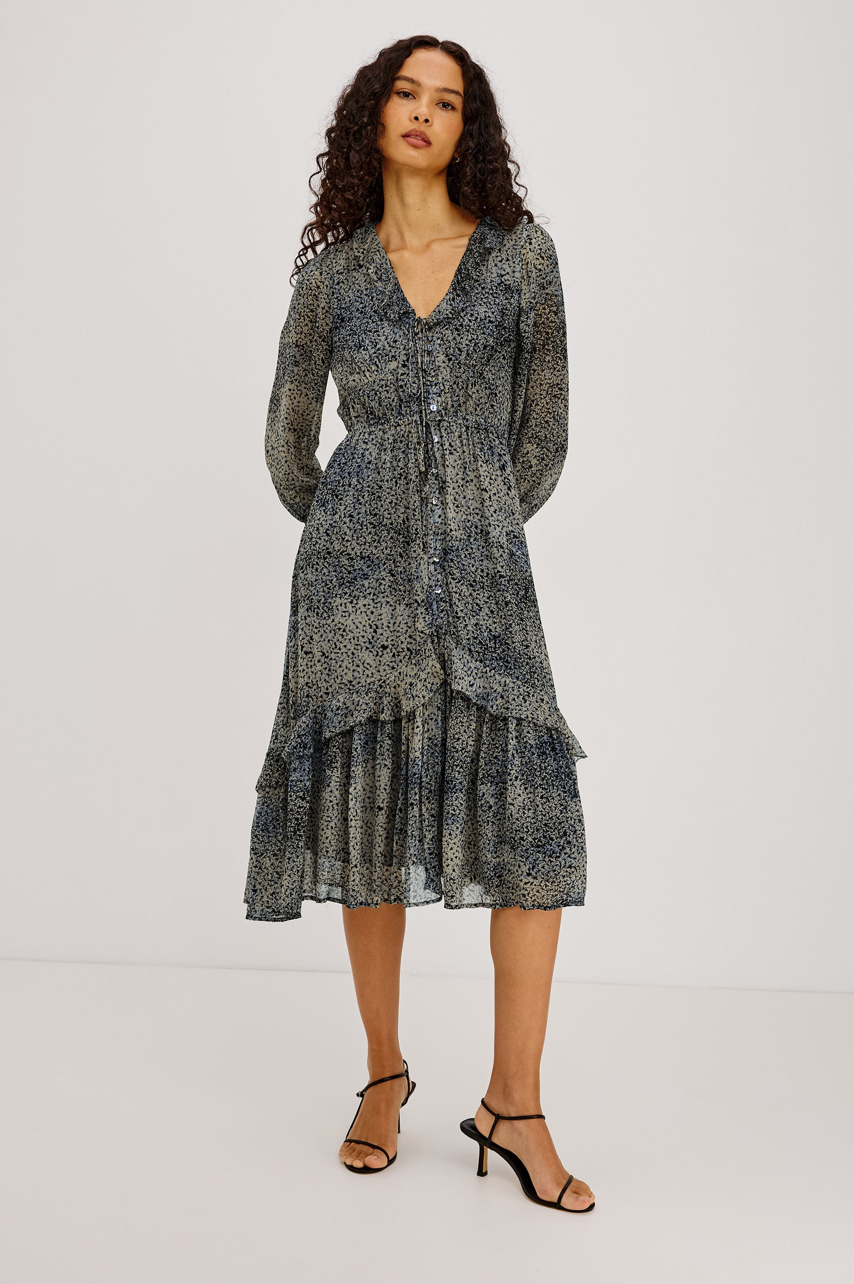 Theresa Midi Dress in Chiffon With Lined Body, Ruffle V-Neckline With Ties, Button-Loop Placket, Elastic Drawstring Waist, Long Semi-Sheer Bishop Sleeves, and Asymmetric Tier at Skirt in Agate Colorway - Full Body Front View Featured on Model