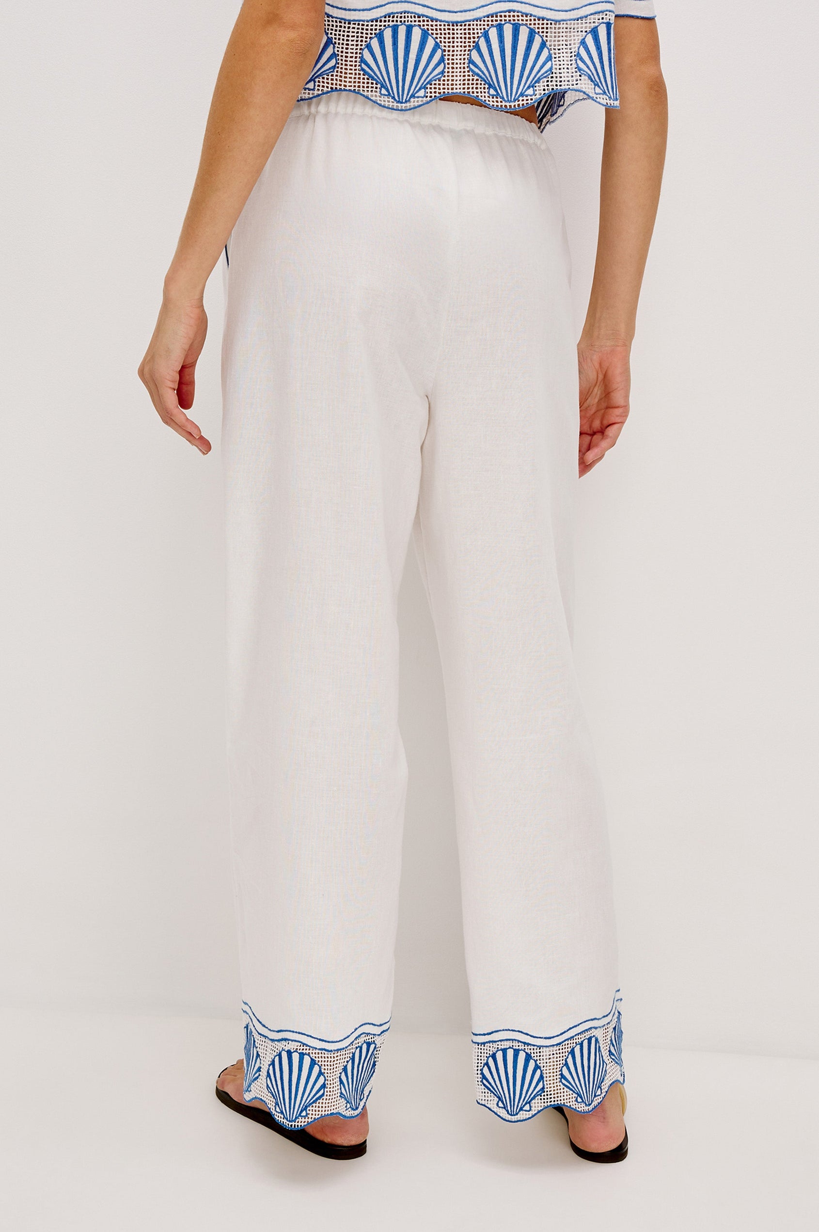 Tildi Drawstring Pant with Side Pockets, Sea Shell Embroidery and Scalloped Hem in White Colorway. Back View Shown on Model.