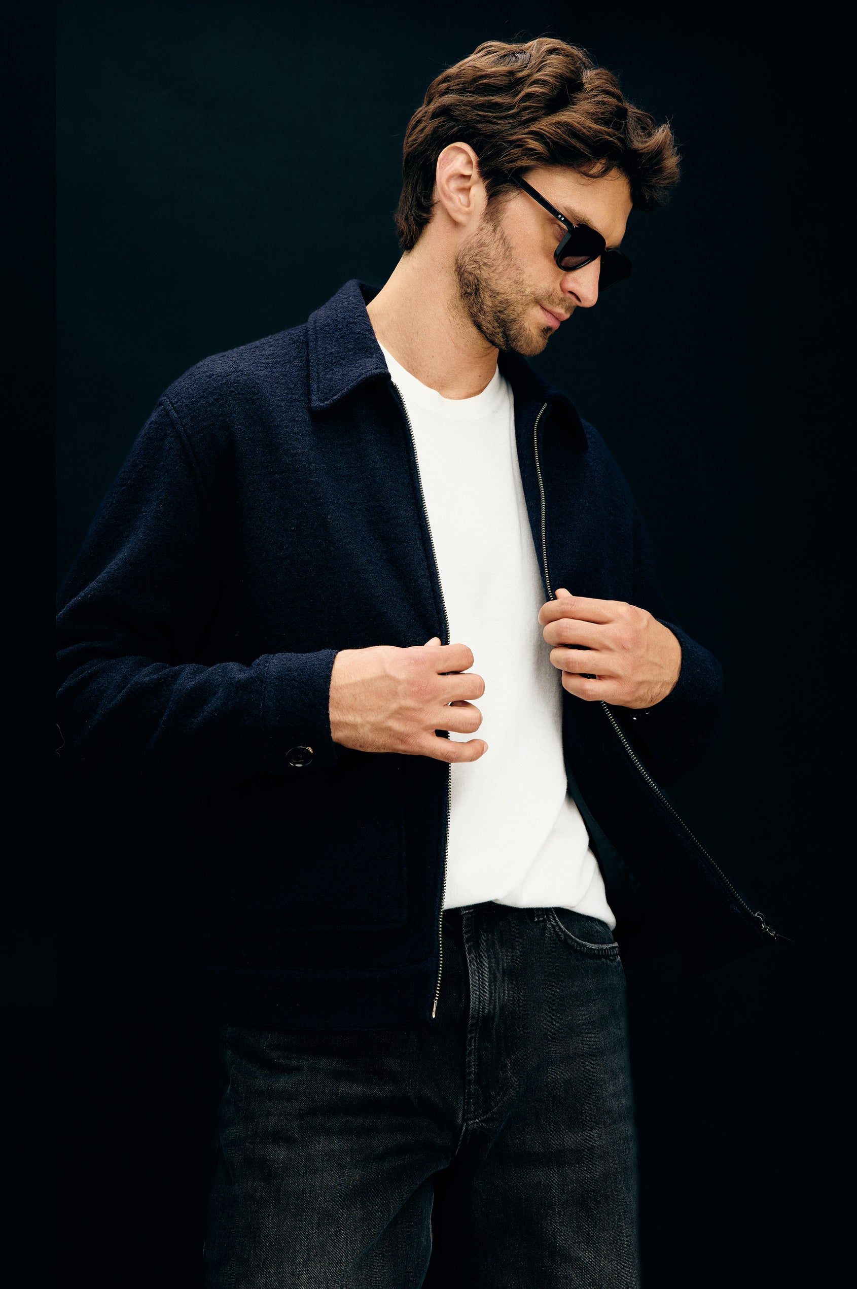 Tilman is a classic collar, front zip jacket, buttoned pockets with top and side entry in Navy Boucle colorway. Front unbuttoned view featured on model.
