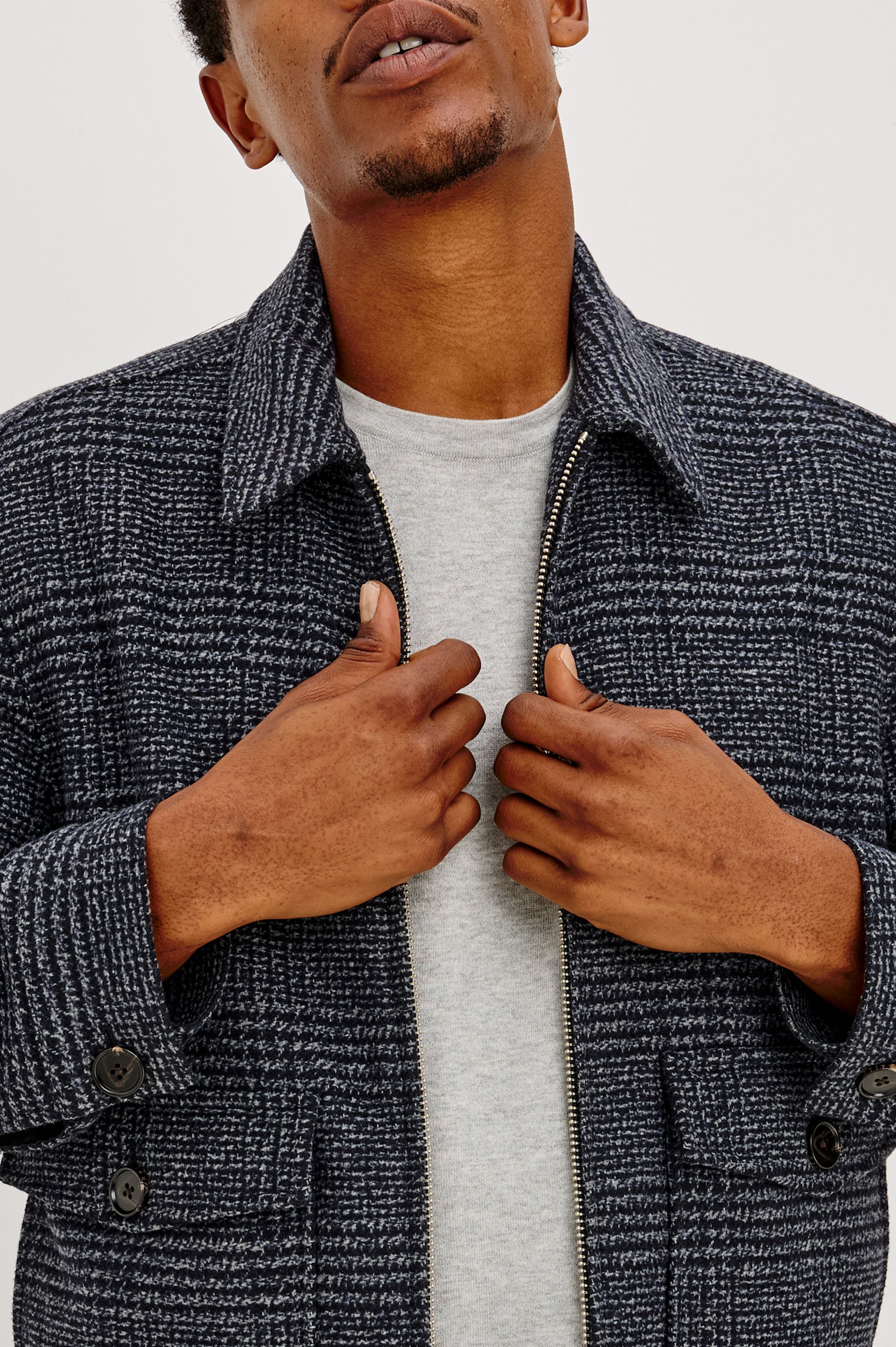 Tillman Jacket in Midweight Textured Wool Blend With Full Custom Lining, Front Zip, Spread Collar, Front Flap Side Entry Pockets, Relaxed FIt, and Long Sleeves in Navy Static Plaid Colorway - Front Close up View Featured on Model.