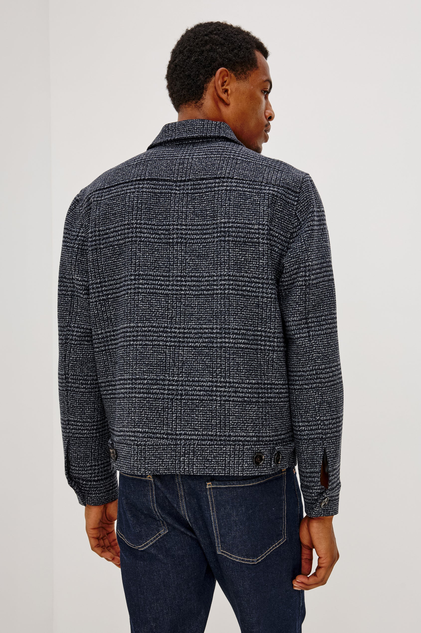 Tillman Jacket in Midweight Textured Wool Blend With Full Custom Lining, Front Zip, Spread Collar, Front Flap Side Entry Pockets, Relaxed FIt, and Long Sleeves in Navy Static Plaid Colorway - Back View Featured on Model.