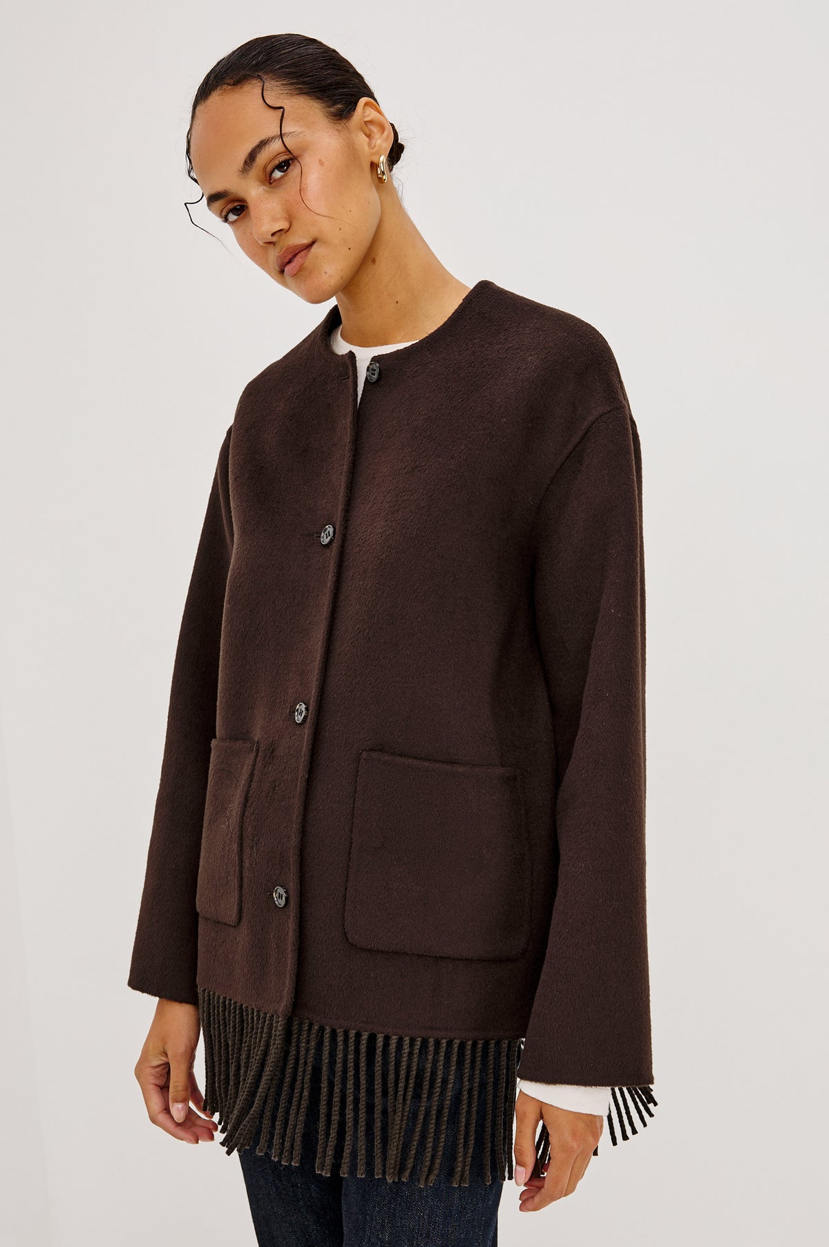 Tomoko Jacket in Heavy Wool Blend With Collarless Neckline, Front Buttons, Front Patch Pockets, and Fringe Hem in Chocolate Colorway - Side Crop View Featured on Model.