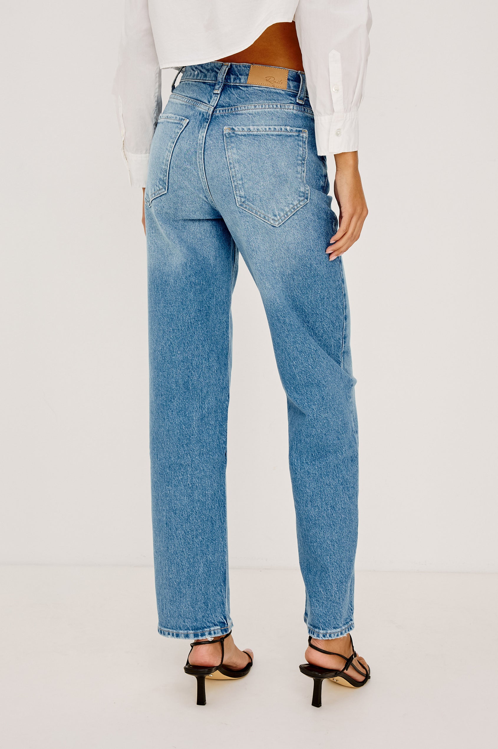 Topanga High-Rise Wide Straight Leg Jean in With 5-Pockets and a Front Zip-Fly in Baja Blue Colorway - back View Featured on Model