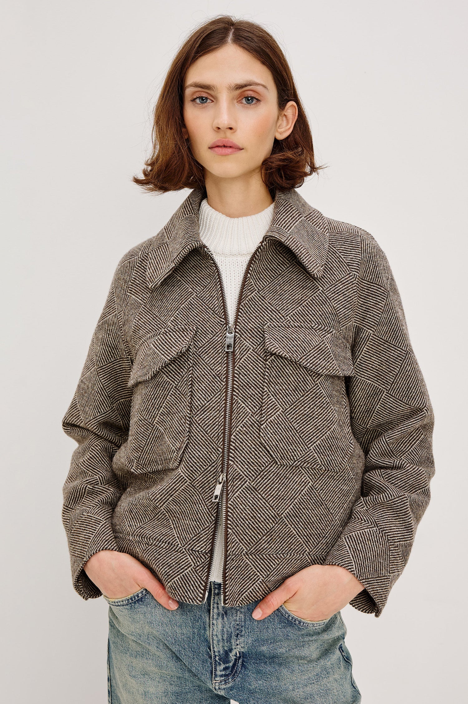 Truckee, a heavyweight wool-blend aviation-style jacket with a textured basketweave pattern. The jacket is fully lined and features oversized flap chest pockets and a two-way front zipper. Front View featured on model, Zipped Up