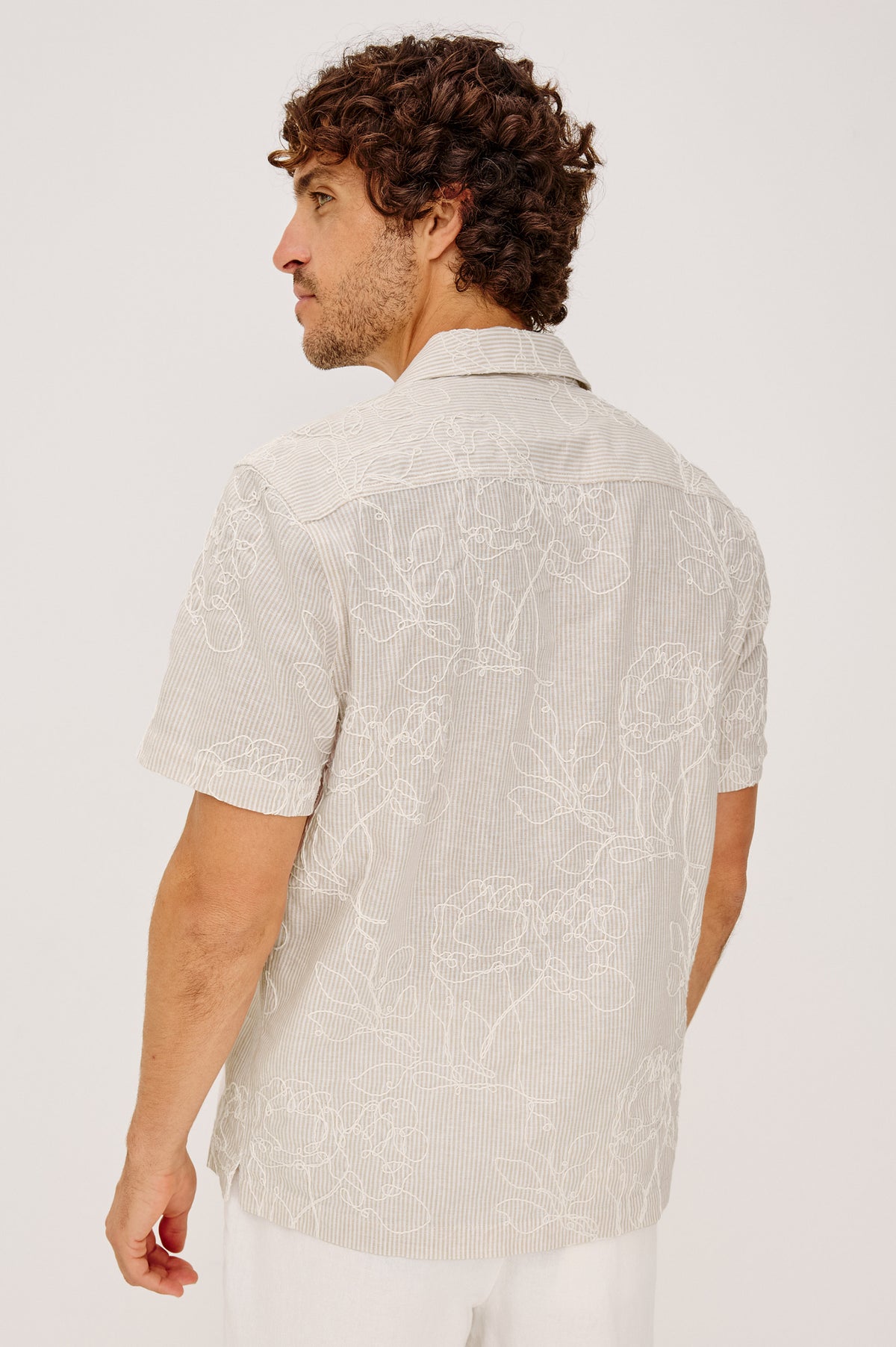 Tyler Camp Shirt in Stretch Cotton With Open Collar, Short Sleeves, and Classic Fit in Bouquet Khaki Stripe Colorway - Upper Body Back View Featured on Model