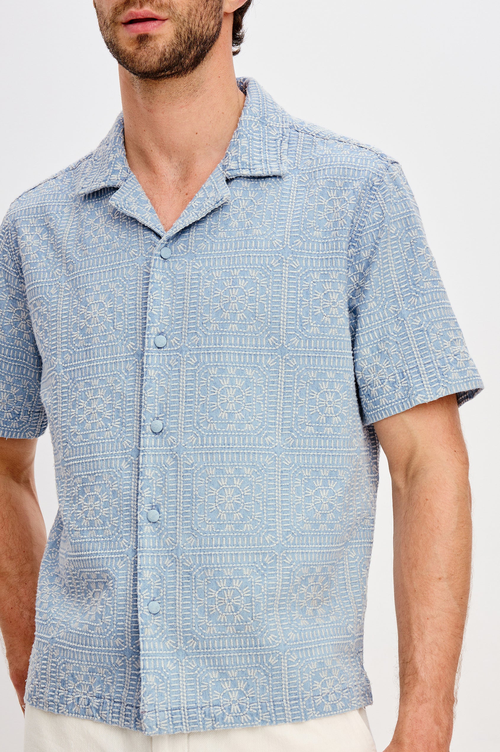 Tyler embroidered short sleeve button up with collar in Indigo Cream Squares colorway - front detail view featured on model