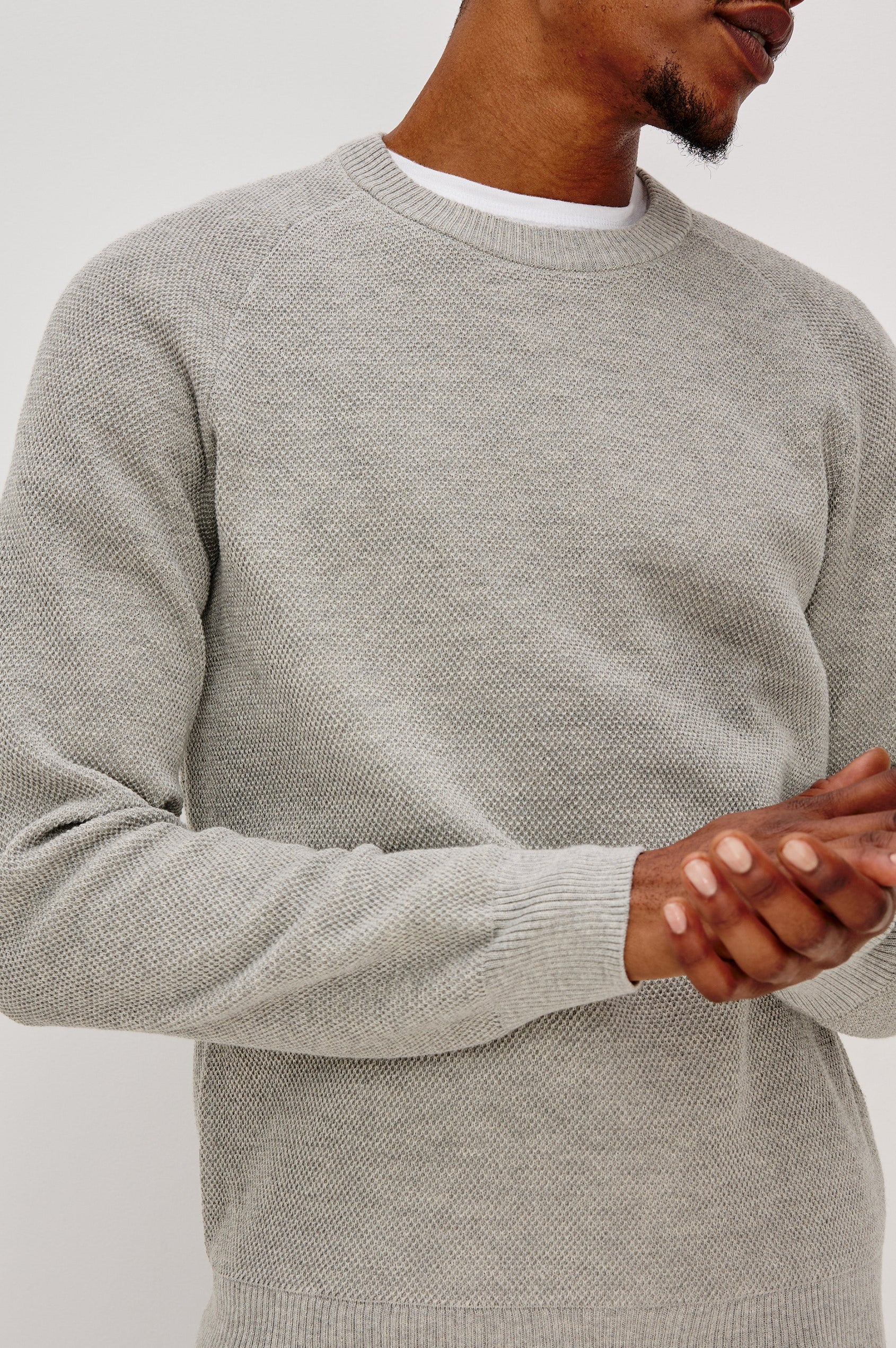Vann long sleeve crew neck sweater in Grey Heather Colorway. Front Detail View on Model Shown.