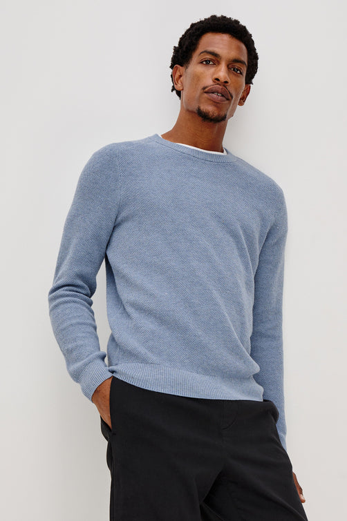 Vann long sleeve crew neck sweater in Light Blue Heather Colorway. Front View on Model Shown.
