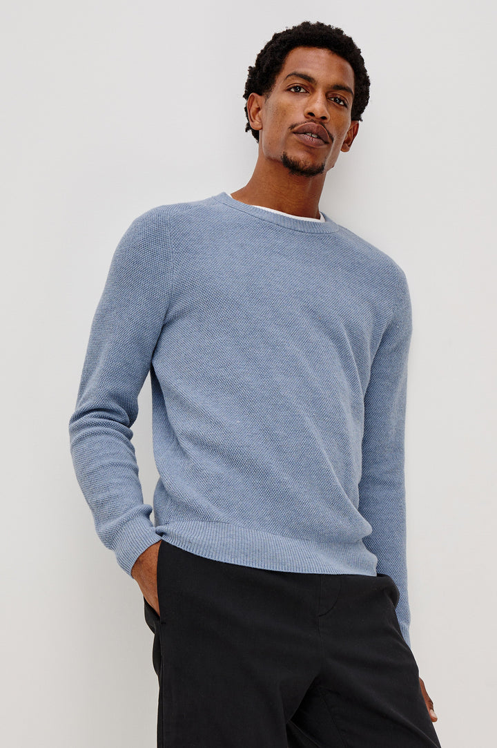 Vann long sleeve crew neck sweater in Light Blue Heather Colorway. Front View on Model Shown.